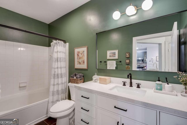 full bathroom featuring tile patterned floors, shower / tub combo with curtain, vanity, and toilet