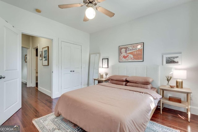 bedroom featuring a closet, ceiling fan, and dark hardwood / wood-style flooring