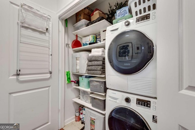 washroom featuring stacked washer / drying machine