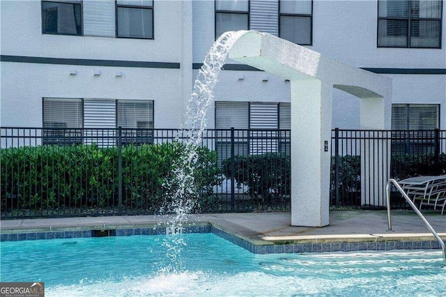 view of swimming pool featuring pool water feature