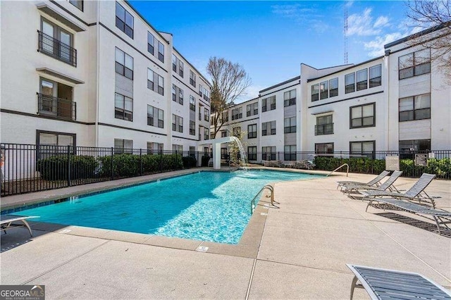 view of pool with pool water feature and a patio