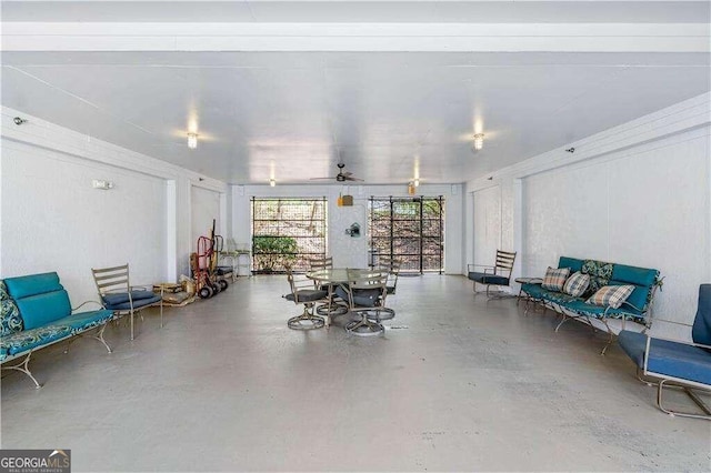 misc room featuring ceiling fan and concrete flooring