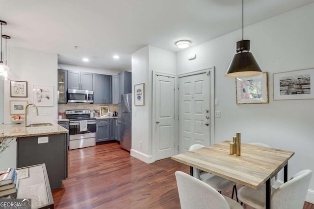 dining room with dark hardwood / wood-style flooring and sink