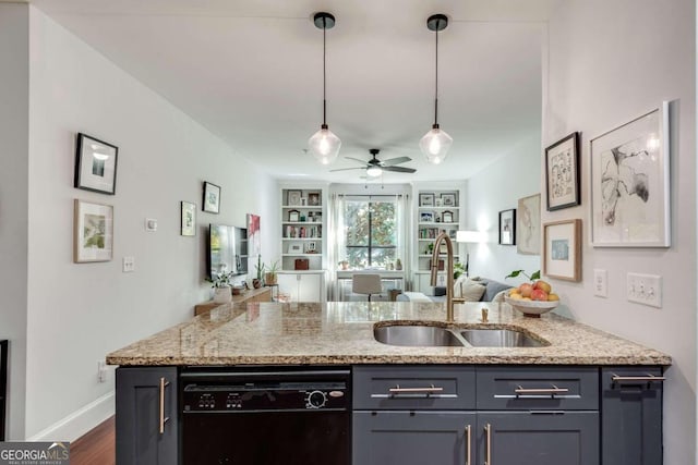 kitchen with light stone countertops, sink, hanging light fixtures, and black dishwasher