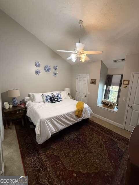 carpeted bedroom featuring ceiling fan and lofted ceiling