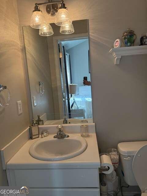 bathroom featuring vanity and toilet