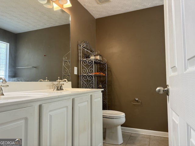 bathroom featuring tile patterned flooring, a textured ceiling, and toilet