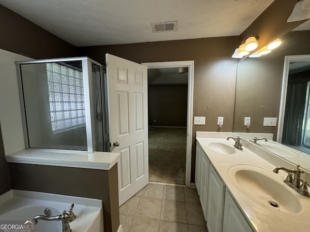 bathroom with vanity, a textured ceiling, tile patterned floors, and independent shower and bath