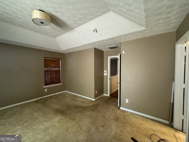 unfurnished room featuring carpet flooring, a textured ceiling, and lofted ceiling