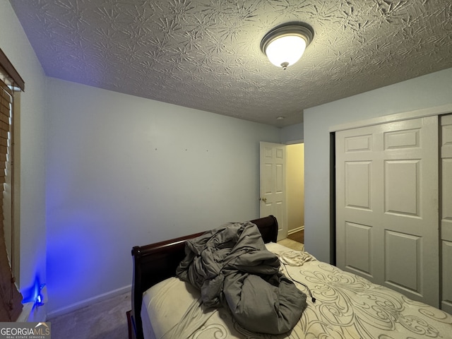 unfurnished bedroom with carpet floors, a textured ceiling, and a closet