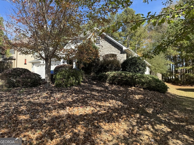 view of side of home with a garage