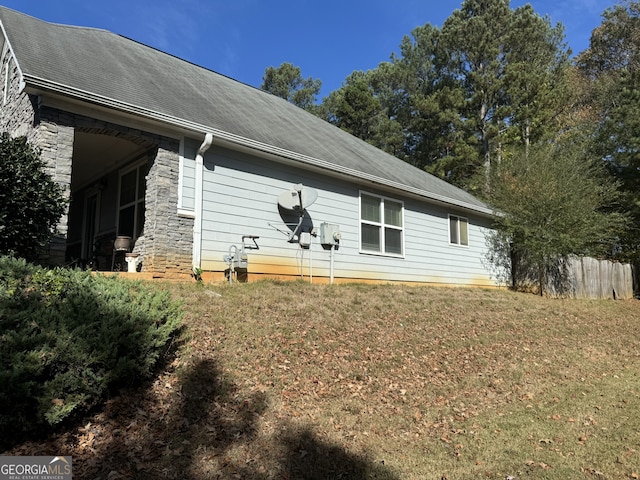 view of property exterior with a lawn