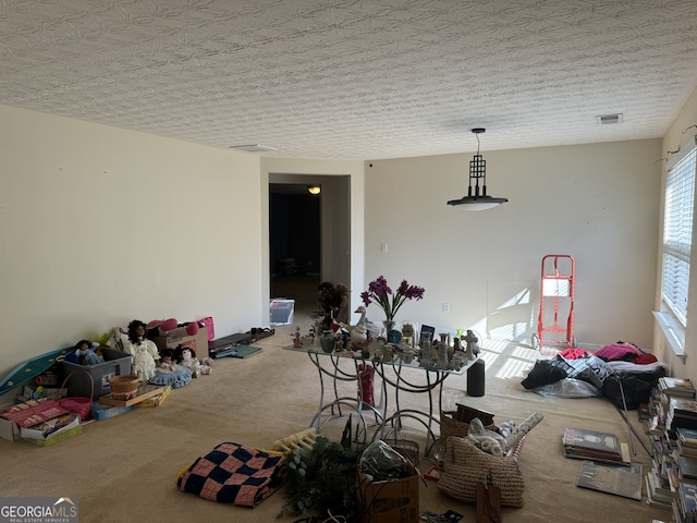 dining space with carpet and a textured ceiling