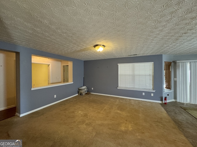 interior space featuring carpet, a healthy amount of sunlight, and a textured ceiling