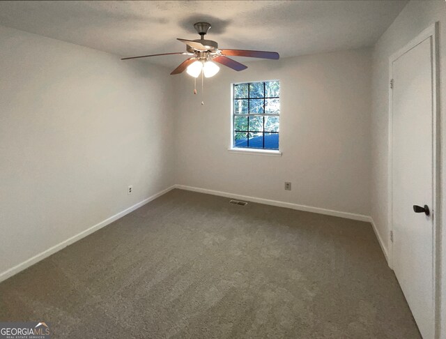 carpeted empty room with ceiling fan