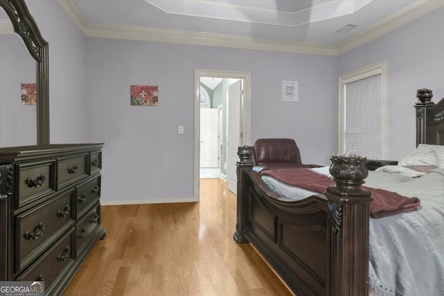 bedroom with light hardwood / wood-style floors and crown molding