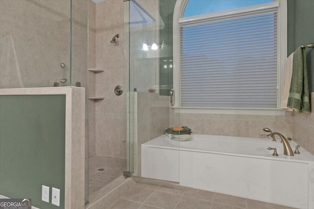 bathroom with tile patterned flooring and shower with separate bathtub