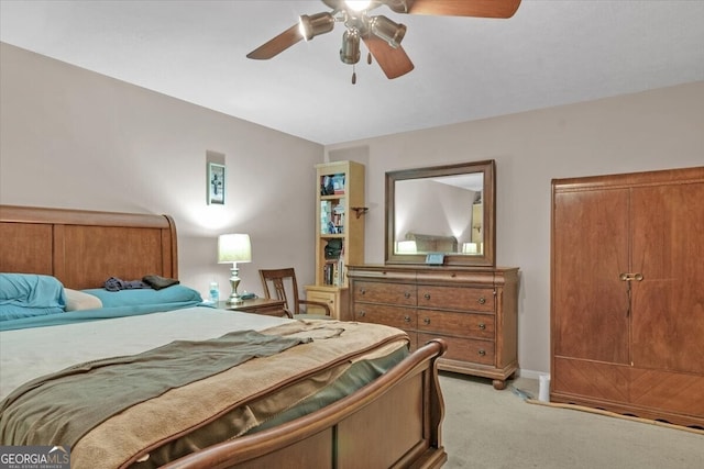 bedroom with ceiling fan, light colored carpet, and vaulted ceiling