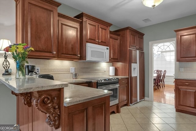 kitchen featuring tasteful backsplash, light stone counters, paneled refrigerator with ice dispenser, stainless steel range with electric stovetop, and light tile patterned flooring