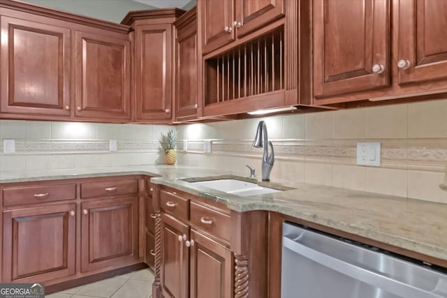 kitchen with light stone countertops, dishwasher, sink, backsplash, and light tile patterned floors