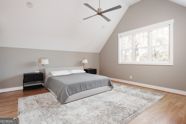 bedroom featuring wood-type flooring, vaulted ceiling, and ceiling fan