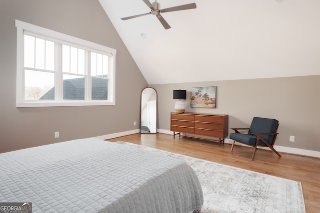 bedroom featuring ceiling fan, vaulted ceiling, and light wood-type flooring