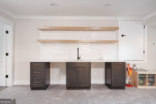 bar featuring dark brown cabinets, crown molding, and sink