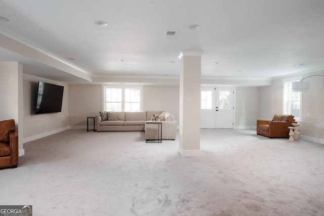 living room featuring light carpet, french doors, plenty of natural light, and ornamental molding