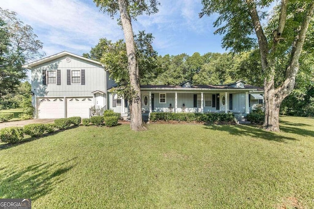 view of front facade featuring a front lawn, a porch, and a garage