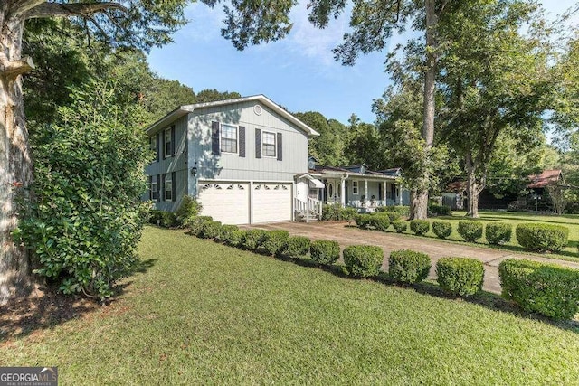 view of front of property featuring a garage and a front lawn