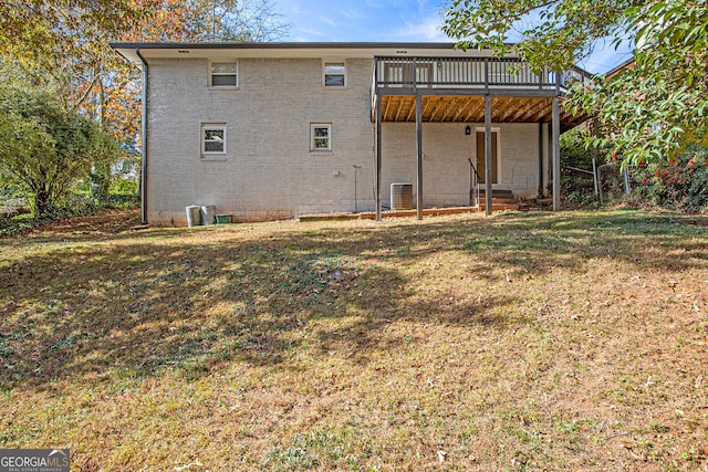 back of house with a yard, central AC, and a wooden deck