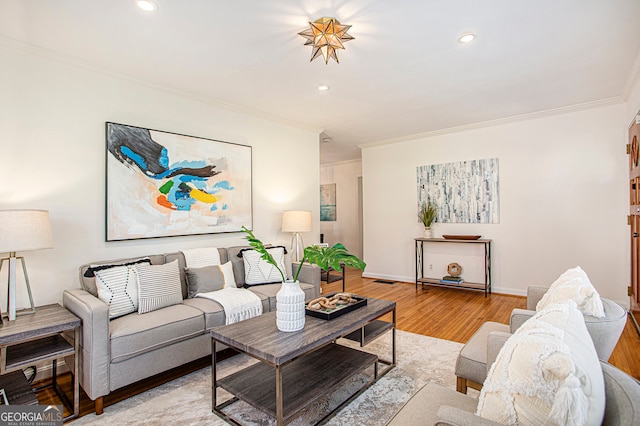 living room with light hardwood / wood-style floors and ornamental molding