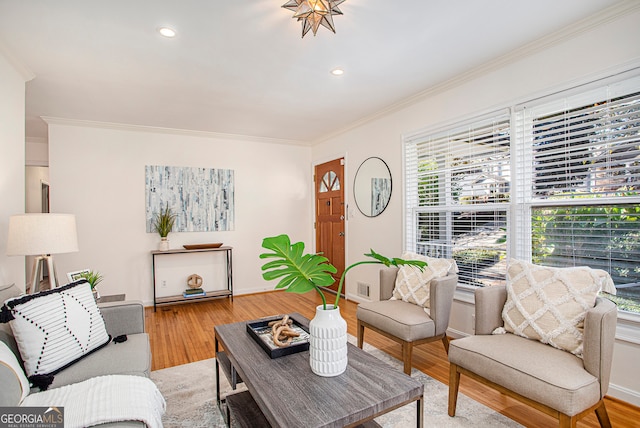 living room featuring hardwood / wood-style flooring and ornamental molding