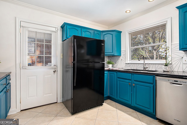 kitchen with sink, black fridge, stainless steel dishwasher, blue cabinets, and backsplash