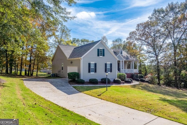 view of front of house with a front yard, a garage, and central AC unit