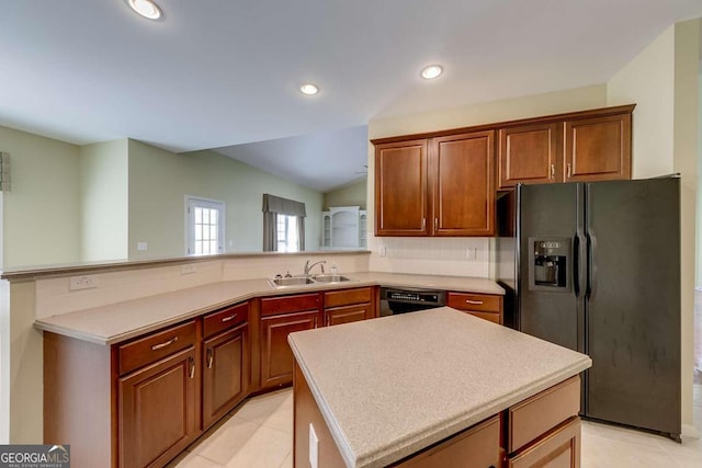 kitchen with sink, a center island, black appliances, decorative backsplash, and vaulted ceiling