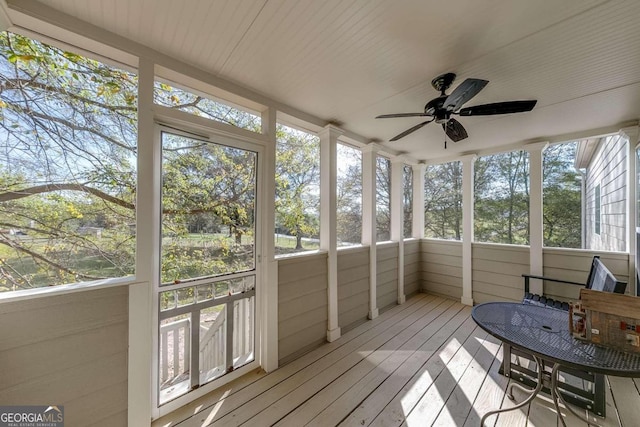 sunroom featuring wood ceiling and ceiling fan