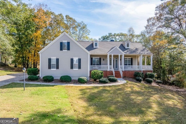 new england style home featuring a front lawn and a porch