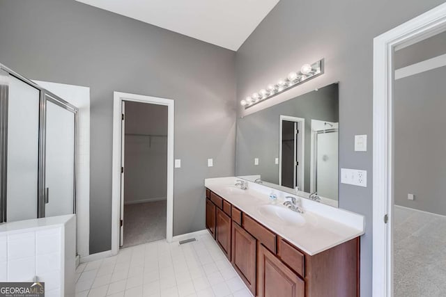 bathroom featuring vanity and an enclosed shower