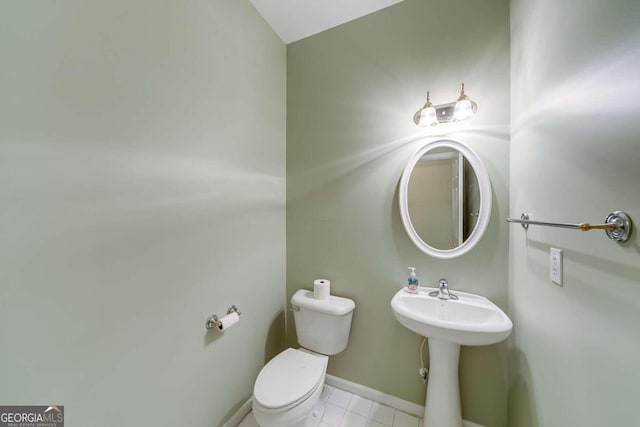 bathroom with tile patterned flooring, sink, and toilet