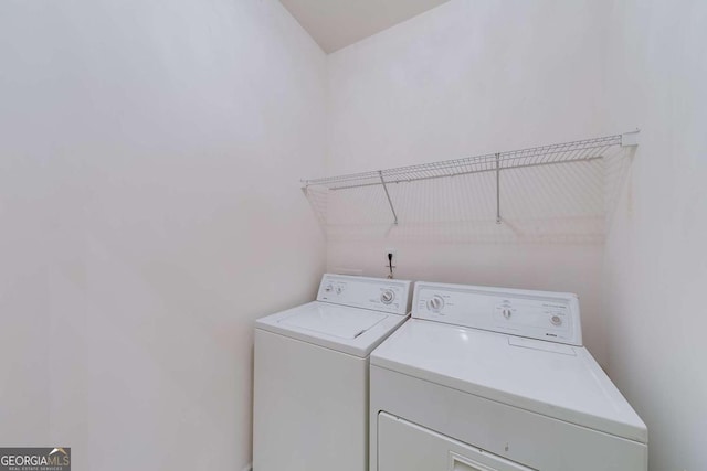 clothes washing area with separate washer and dryer