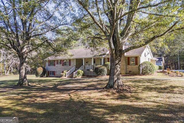 ranch-style home featuring a porch and a front yard