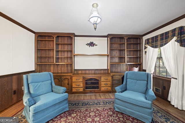 living area featuring crown molding, dark hardwood / wood-style flooring, and wooden walls