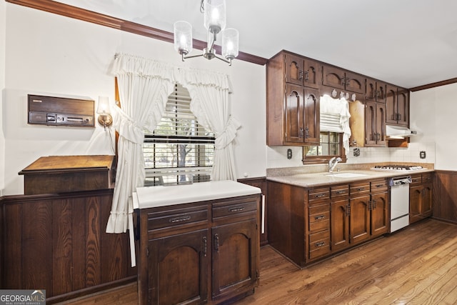 kitchen with dark brown cabinets, white appliances, dark hardwood / wood-style floors, and sink