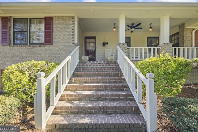 view of exterior entry featuring ceiling fan and a porch