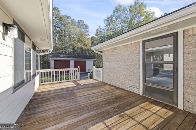 wooden terrace featuring an outbuilding