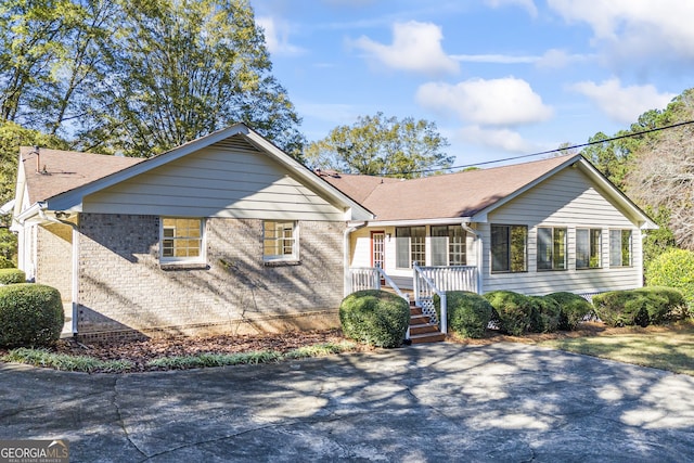 single story home featuring covered porch