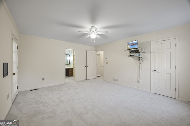 unfurnished bedroom featuring ceiling fan, ornamental molding, and light carpet