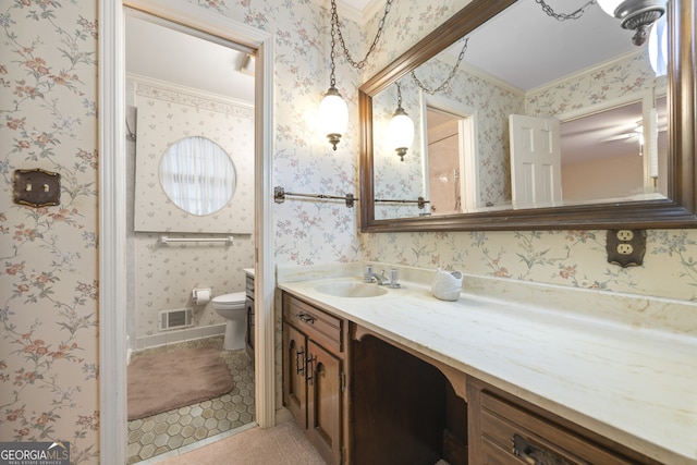 bathroom with tile patterned flooring, vanity, toilet, and ornamental molding