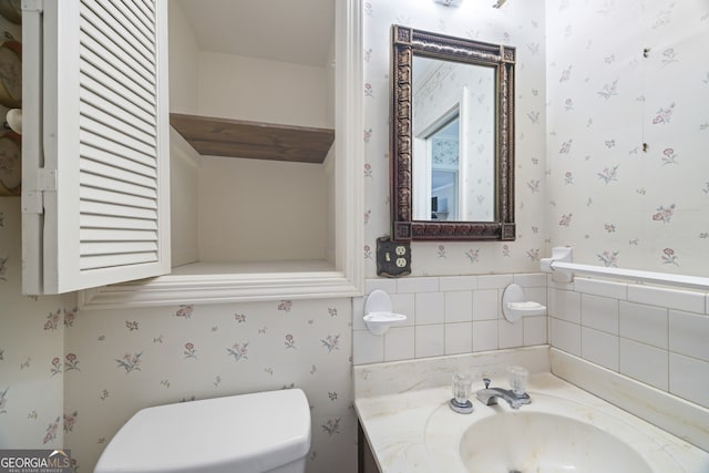 bathroom featuring vanity and toilet